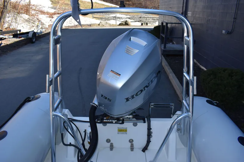 Slide: The Image of Ribcraft 5.85 boat with Honda 135 outboard motor, 2020 model, parked outdoors. - 13