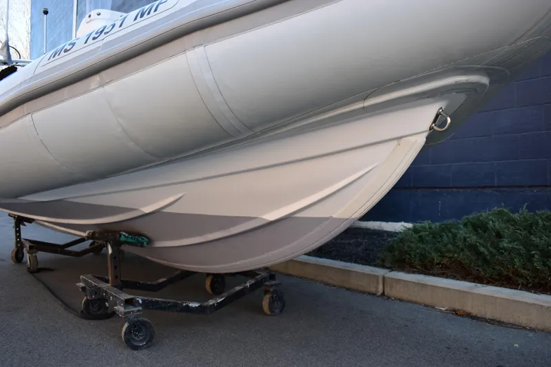 Slide: The Image of 2020 Ribcraft 5.85 boat hull on trailer, parked on pavement. - 14