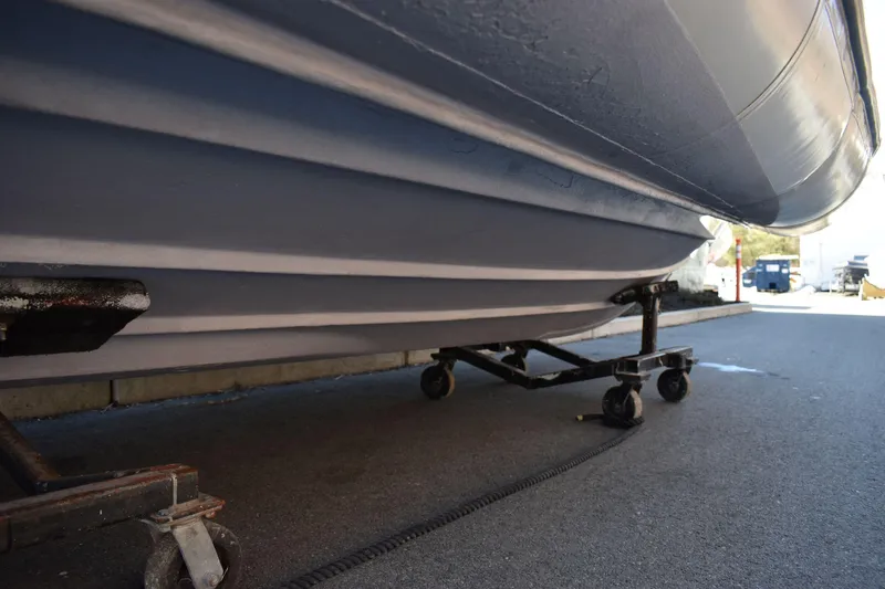 Slide: The Image of Ribcraft 5.85 boat hull on wheeled dolly, 2020 model, parked on asphalt. - 15