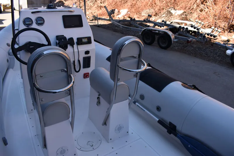 Slide: The Image of 2020 Ribcraft 5.85 boat interior with steering console and seating. - 3