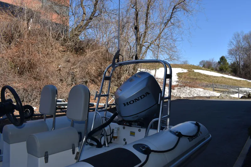 Slide: The Image of 2020 Ribcraft 5.85 boat with Honda engine, parked outdoors in winter landscape. - 4