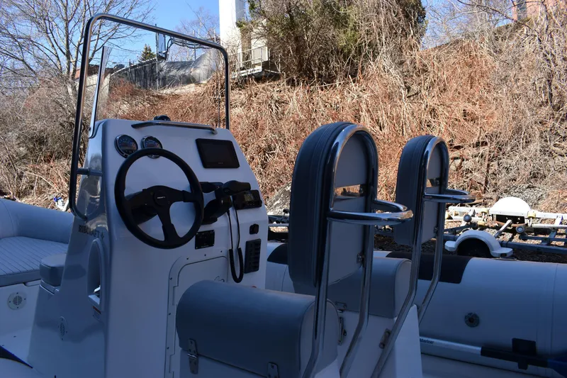 Slide: The Image of 2020 Ribcraft 5.85 boat interior with steering console and seating. - 9