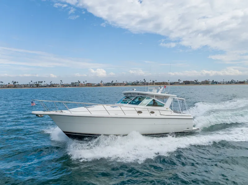Slide: The Image of 2004 Tiara Yachts 4000 cruising on open sea under blue sky. - 16