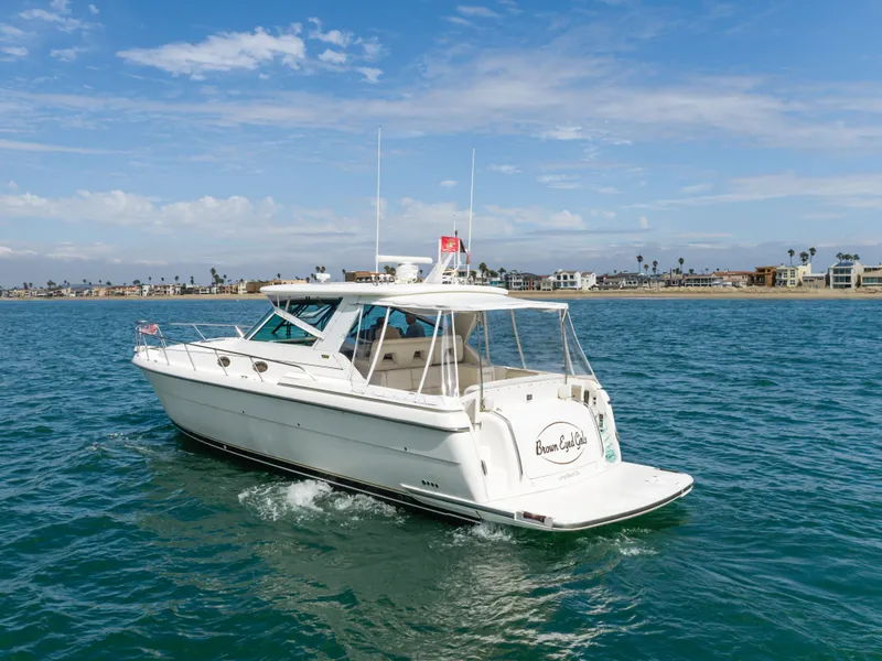 Slide: The Image of 2004 Tiara Yachts 4000 cruising on open water near coastline. - 2