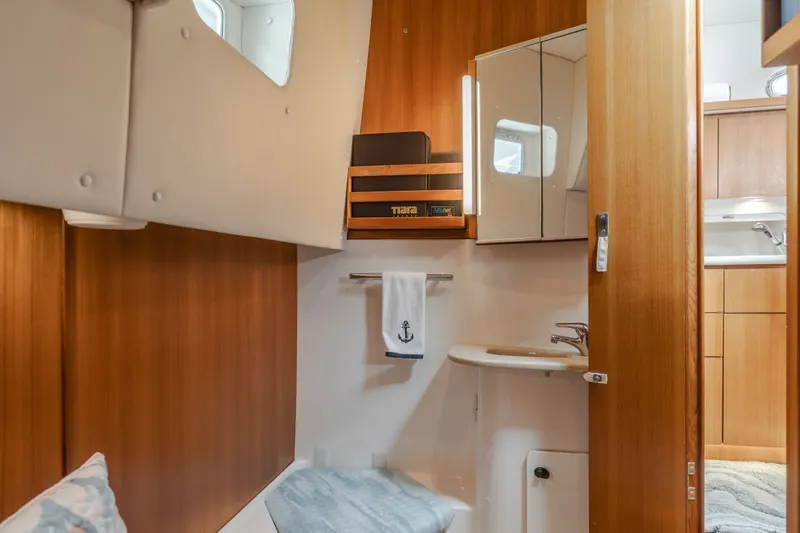 Slide: The Image of Interior of a 2004 Tiara Yachts 4000, featuring wood paneling and sink. - 40
