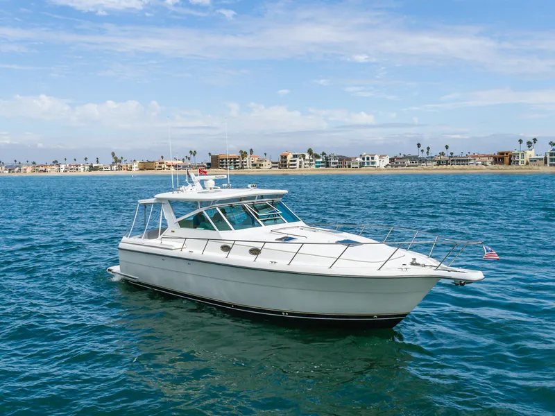 Slide: The Image of 2004 Tiara Yachts 4000 on calm waters near coastline. - 7