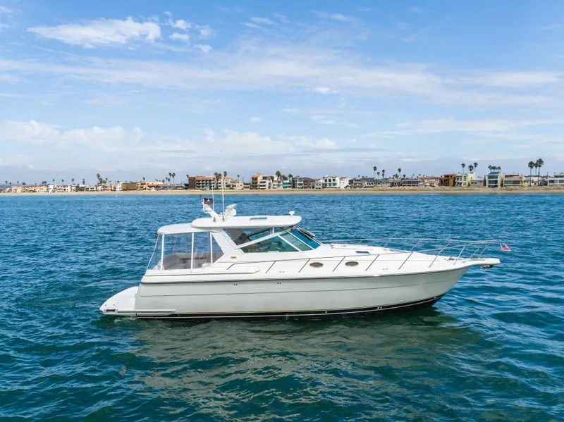 Slide: The Image of 2004 Tiara Yachts 4000 on open sea near coastline. - 8