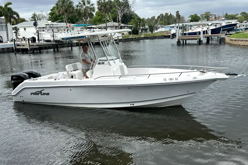 Slide: The Image of 2014 Pro-Line 26 Super Sport boat cruising on a calm waterway. - 20