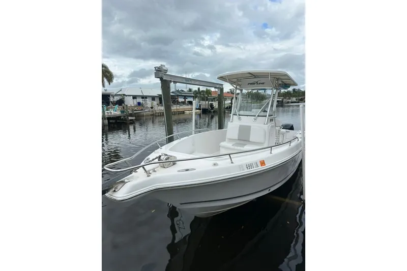 Slide: The Image of 2014 Pro-Line 26 Super Sport boat docked by the waterfront. - 22