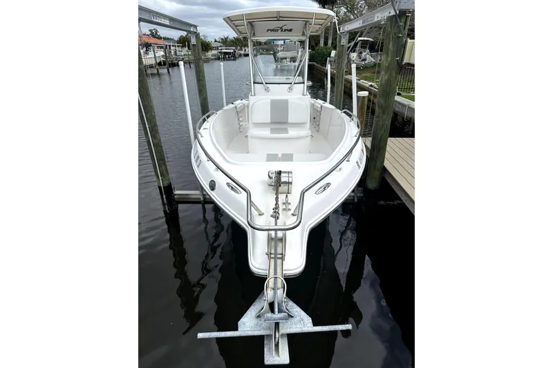 Slide: The Image of 2014 Pro-Line 26 Super Sport boat docked in a marina. - 24
