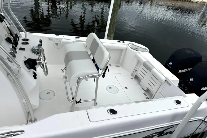 Slide: The Image of 2014 Pro-Line 26 Super Sport boat interior with seating and dual Mercury engines. - 32
