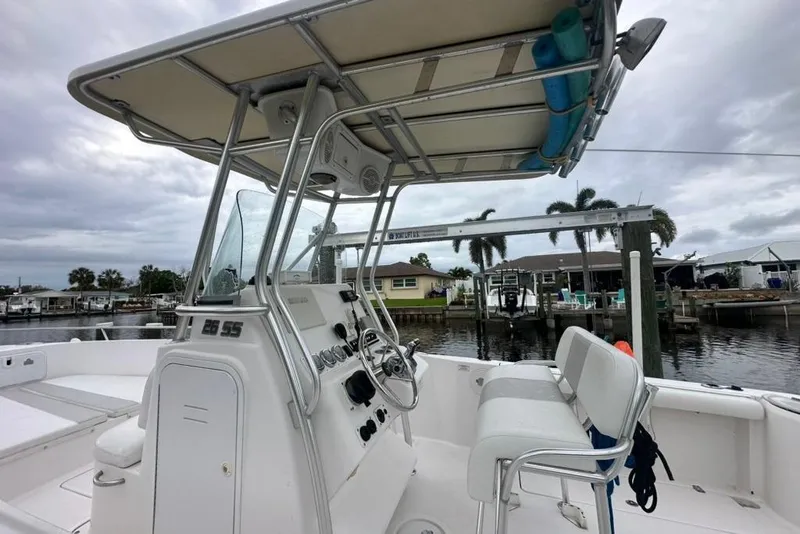 Slide: The Image of 2014 Pro-Line 26 Super Sport boat with T-top, docked in a marina setting. - 33