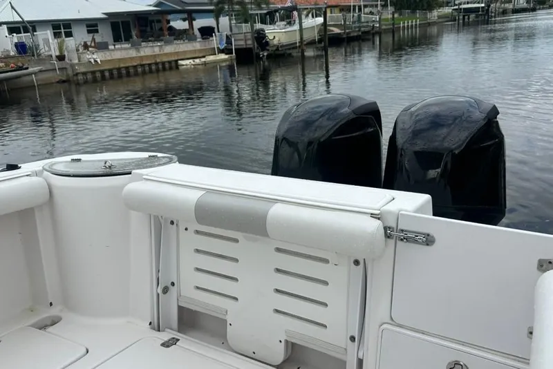 Slide: The Image of 2014 Pro-Line 26 Super Sport boat with dual engines docked by waterfront homes. - 35