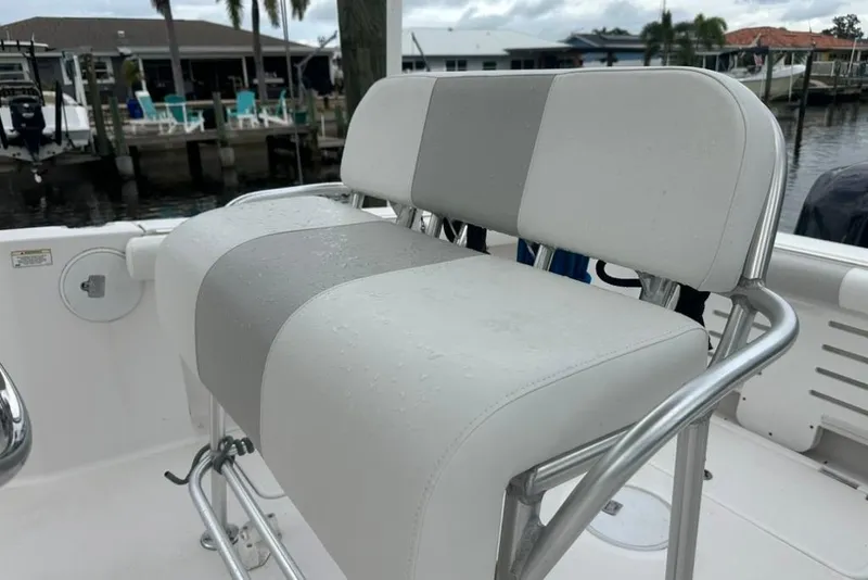 Slide: The Image of 2014 Pro-Line 26 Super Sport boat seat with sleek design and water droplets. - 42