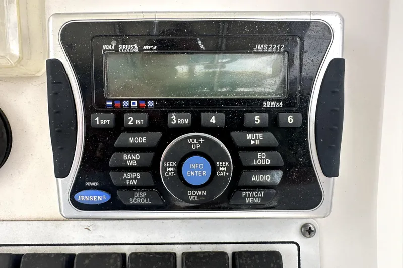 Slide: The Image of Jensen marine stereo system on 2014 Pro-Line 26 Super Sport boat dashboard. - 51