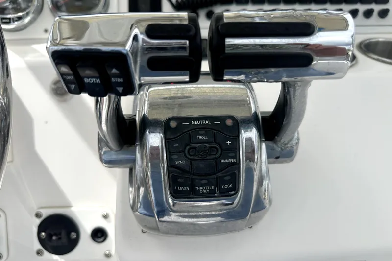 Slide: The Image of Throttle controls on a 2014 Pro-Line 26 Super Sport boat dashboard. - 52