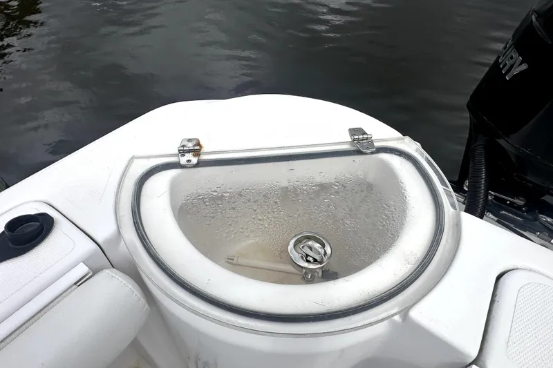 Slide: The Image of Livewell on 2014 Pro-Line 26 Super Sport boat, featuring a transparent lid and water droplets. - 56