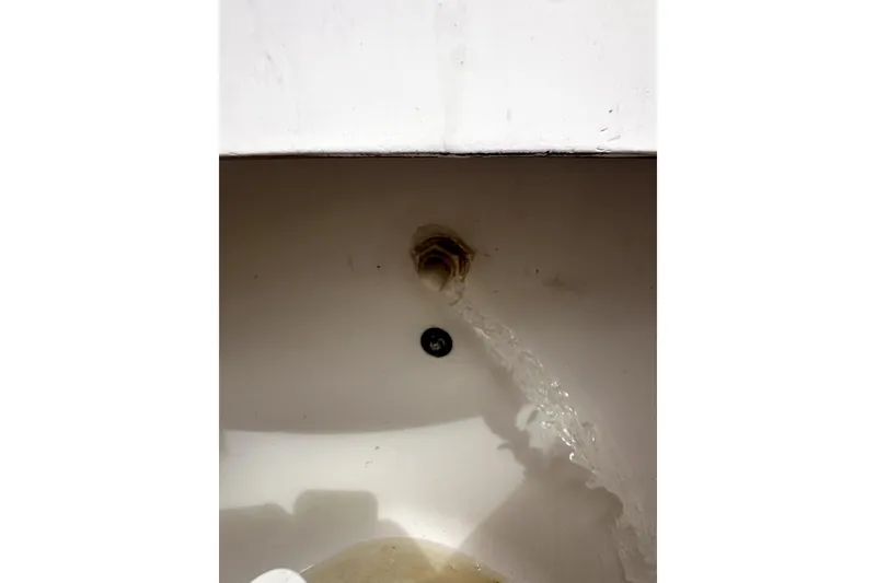 Slide: The Image of Water flowing from a pipe inside a 2014 Pro-Line 26 Super Sport boat. - 58