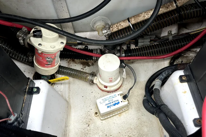 Slide: The Image of Bilge area of 2014 Pro-Line 26 Super Sport boat with wiring and pump components. - 59