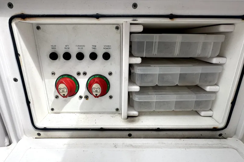 Slide: The Image of Control panel and storage compartments on a 2014 Pro-Line 26 Super Sport boat. - 62