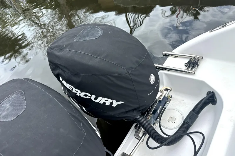 Slide: The Image of Covered Mercury outboard motors on a 2014 Pro-Line 26 Super Sport boat. - 64
