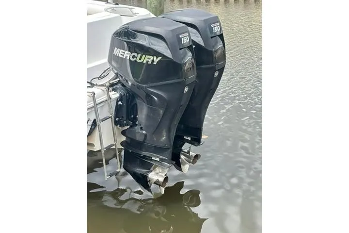Slide: The Image of Twin Mercury 150 outboard motors on a 2014 Pro-Line 26 Super Sport boat. - 65