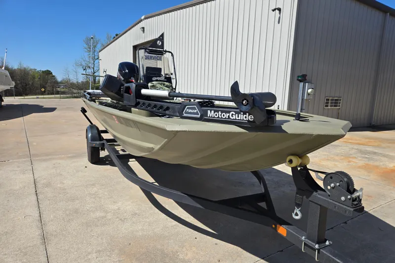 Slide: The Image of 2025 Tracker Grizzly 1860 CC boat on trailer, featuring MotorGuide trolling motor. - 10