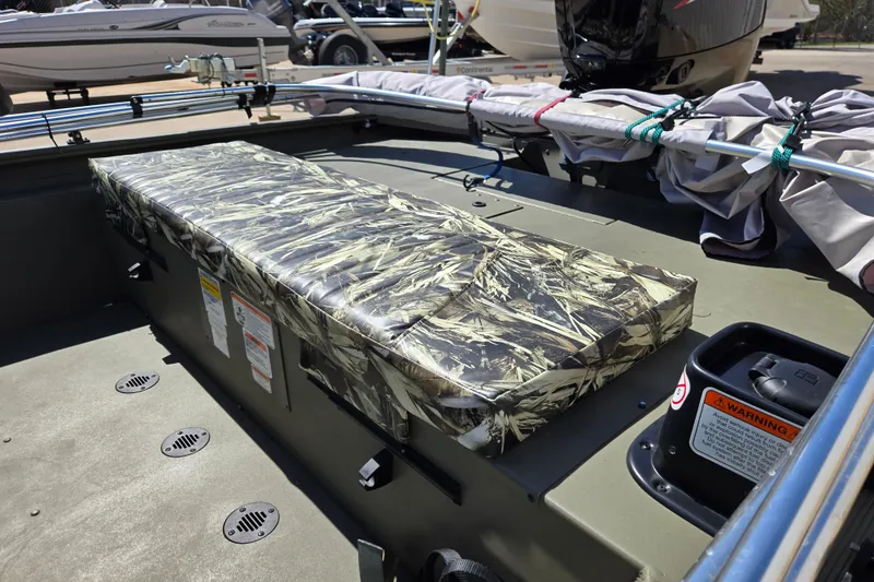 Slide: The Image of 2025 Tracker Grizzly 1860 CC boat interior with camouflage seating and storage. - 13