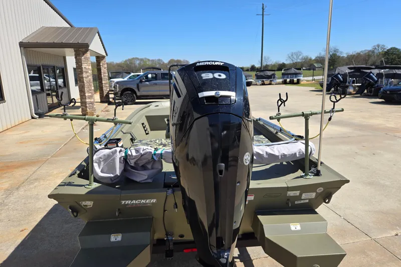 Slide: The Image of 2025 Tracker Grizzly 1860 CC boat with Mercury 90 engine, parked outdoors. - 5