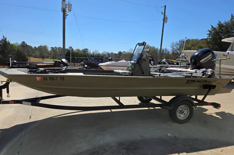 Slide: The Image of 2025 Tracker Grizzly 1860 CC boat on trailer, parked outdoors under clear sky. - 8