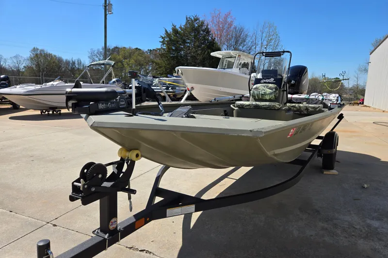 Slide: The Image of 2025 Tracker Grizzly 1860 CC boat on trailer, parked outdoors under clear sky. - 9