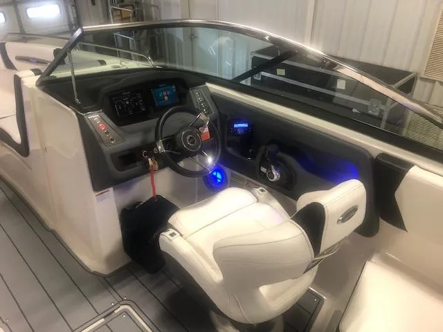 Slide: The Image of Interior of 2022 Chaparral 247 SSX with helm console and seat. - 11