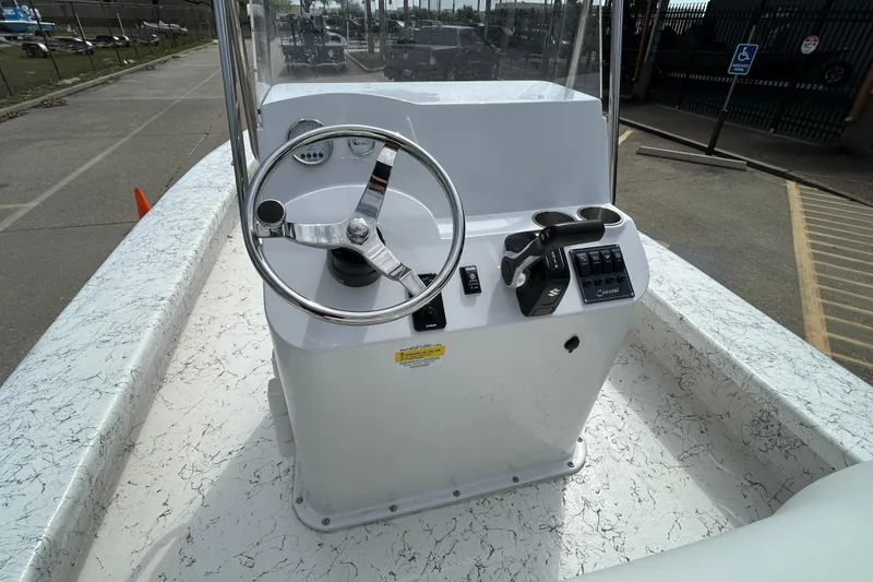 Slide: The Image of 2026 Coastal Skiff 231 Flats boat console with steering wheel and controls. - 11