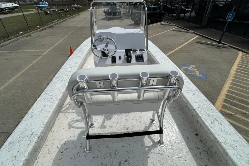 Slide: The Image of 2026 Coastal Skiff 231 Flats boat interior with steering console and rod holders. - 9