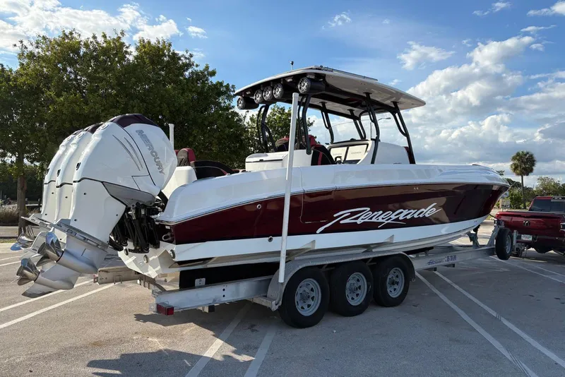 The Image of 2021 Renegade 33 boat on trailer with twin Mercury outboard engines. - 0
