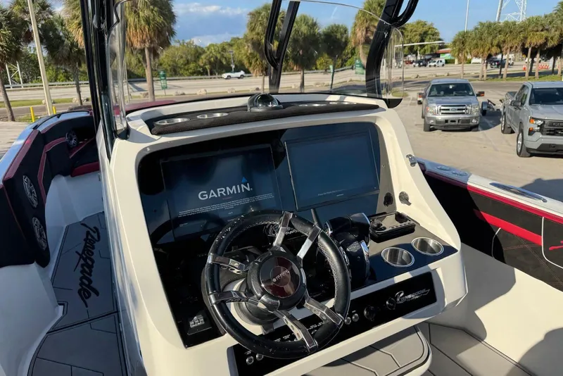 Slide: The Image of Cockpit of 2021 Renegade 33 boat with Garmin navigation system and steering wheel. - 11