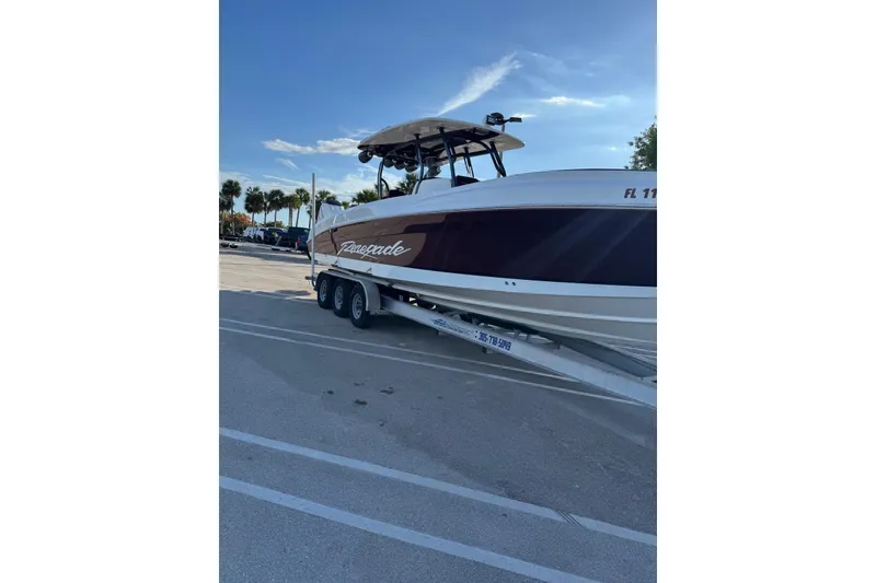 Slide: The Image of 2021 Renegade 33 boat on trailer in sunny parking lot. - 16
