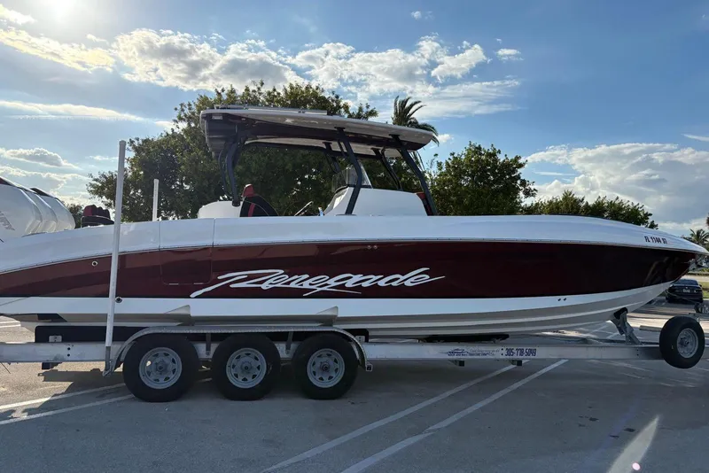 Slide: The Image of 2021 Renegade 33 boat on trailer under a sunny sky. - 17