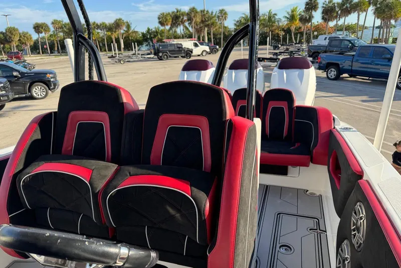 Slide: The Image of Interior of a 2021 Renegade 33 boat with red and black seating. - 18