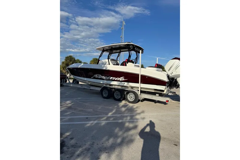 Slide: The Image of 2021 Renegade 33 boat on trailer under clear blue sky. - 7