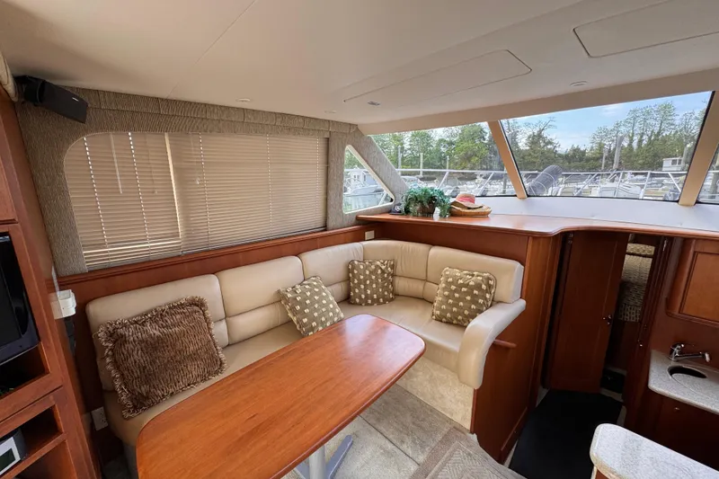 Slide: The Image of Luxurious interior of 2004 Silverton 38 Convertible yacht with plush seating and elegant decor. - 10