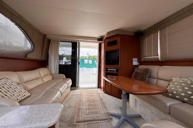 Slide: The Image of Luxurious interior of 2004 Silverton 38 Convertible yacht with plush seating and elegant decor. - 13