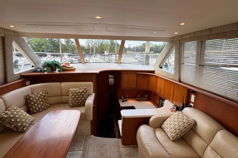 Slide: The Image of Luxurious interior of a 2004 Silverton 38 Convertible yacht with plush seating and elegant decor. - 14
