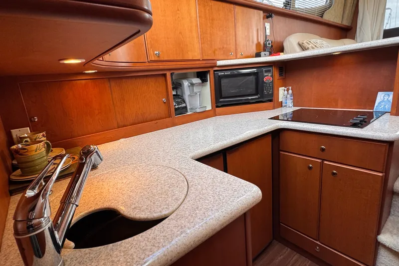Slide: The Image of Luxurious kitchen interior of 2004 Silverton 38 Convertible yacht with modern amenities. - 16