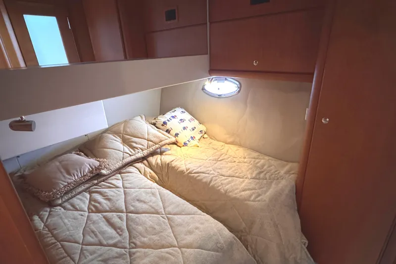 Slide: The Image of Cozy cabin interior of 2004 Silverton 38 Convertible yacht with comfortable bedding. - 18