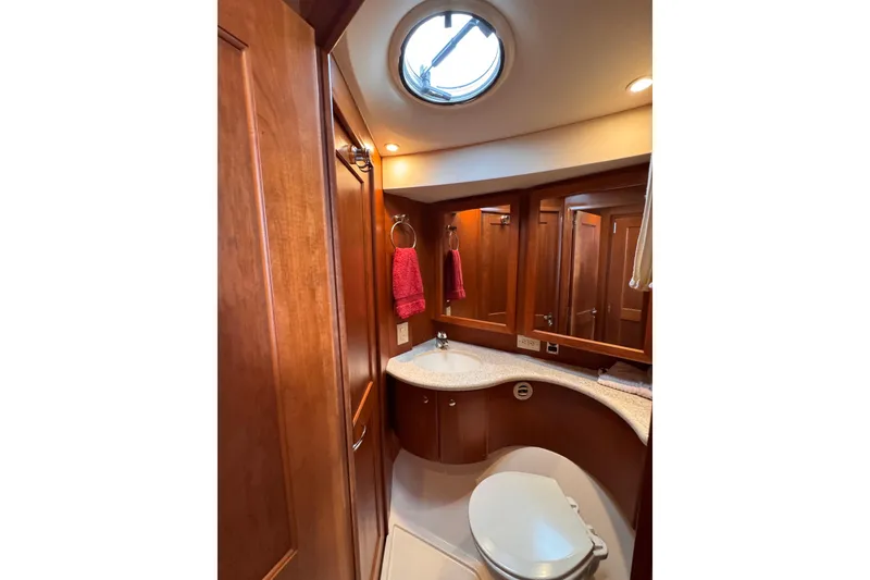 Slide: The Image of Luxurious bathroom in 2004 Silverton 38 Convertible yacht with wood cabinetry and skylight. - 21