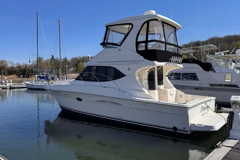 Slide: The Image of 2004 Silverton 38 Convertible yacht docked at marina under clear blue sky. - 3