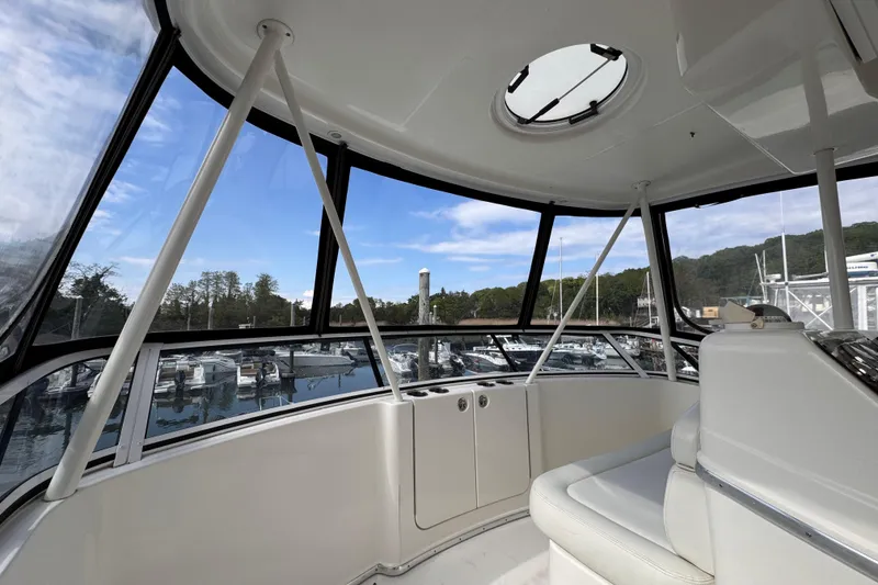 Slide: The Image of Interior view of 2004 Silverton 38 Convertible yacht with marina backdrop. - 34