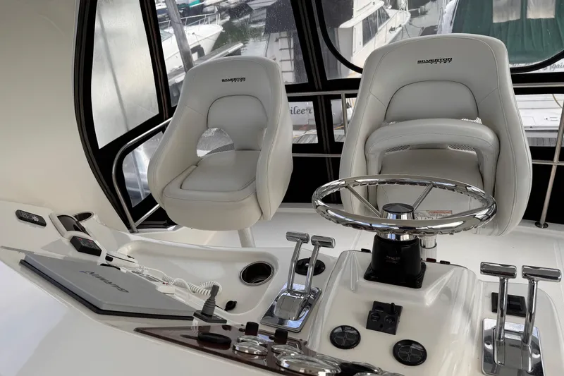 Slide: The Image of Interior helm of 2004 Silverton 38 Convertible yacht with steering wheel and controls. - 37