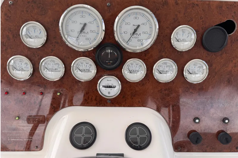 Slide: The Image of 2004 Silverton 38 Convertible dashboard with gauges and controls. - 39